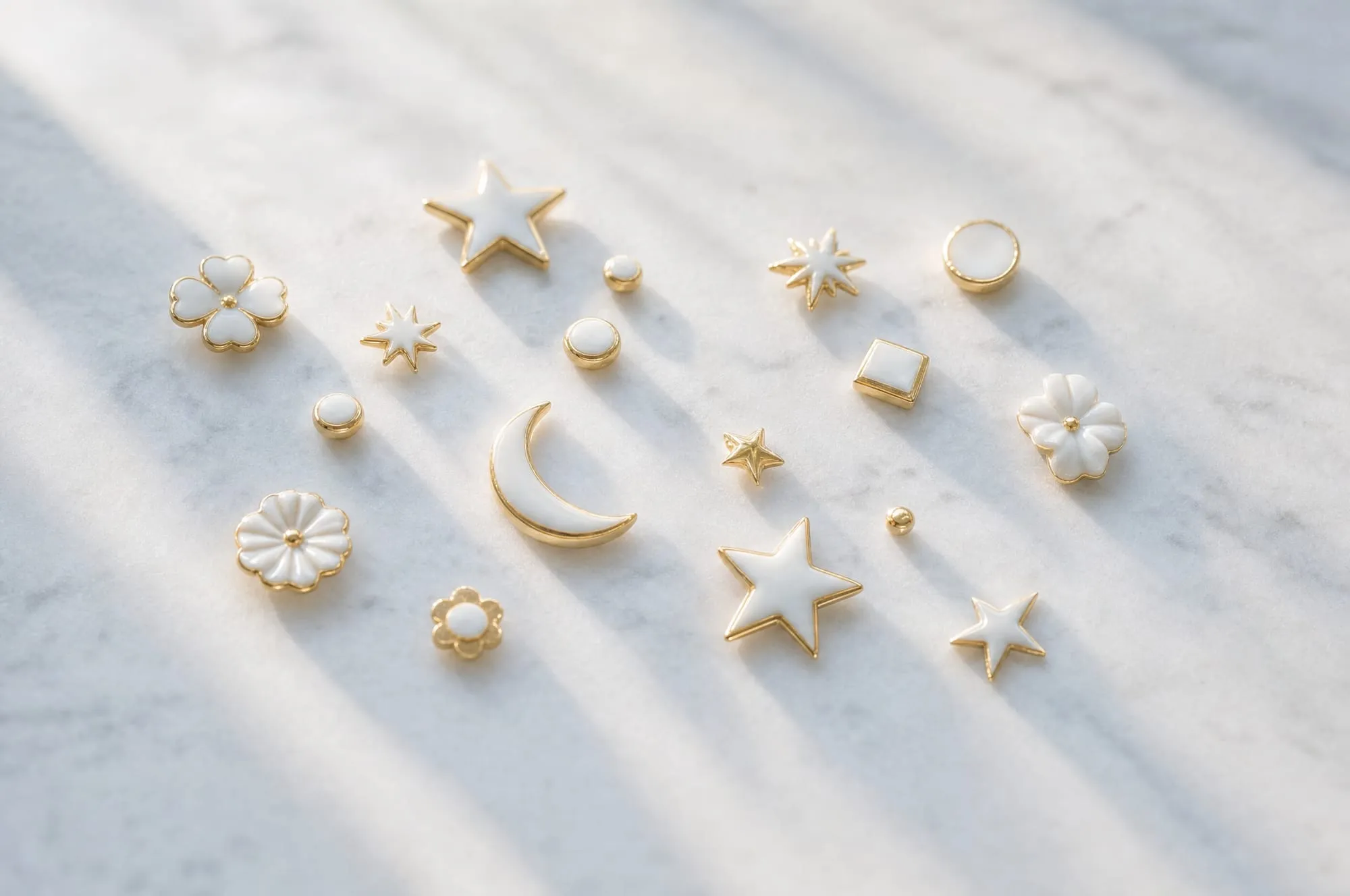 Small white ceramic restoration pieces arranged on pale stone